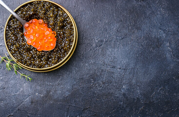 Fresh red and black caviar, seafood, dark background, top view. Good food. Delicious food content