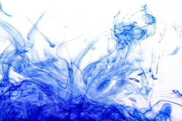 Blue ink injected from syringe, colour mixing with water creating abstract shapes, photo from...