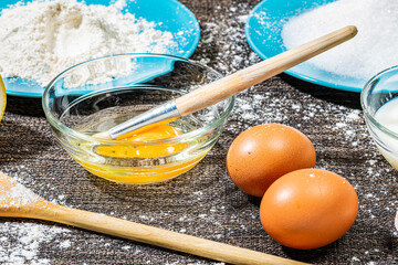 closeup of ingredients to prepare cake with eggs and flour