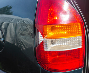 damage to the taillight of the car, accident. Car insurance, background, close-up © HENADZY