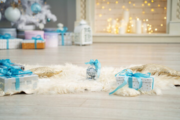 Fototapeta na wymiar furry skin with gift boxes with turquoise bows lies on floor in beautiful room