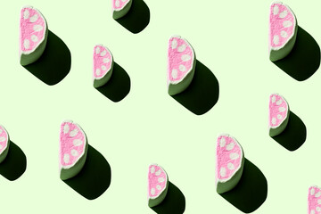 Pattern of tasty marshmallows with hard shadows on a pastel green background.