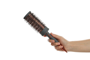Female hand holds hair brush, isolated on white background