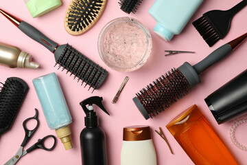 Composition with hairdresser accessories on pink background, top view