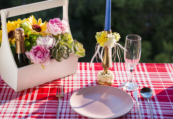 A bottle of champagne and a bouquet of flowers on a white background.