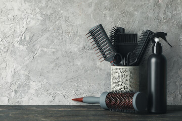 Composition with hairdresser accessories on wooden table, space for text
