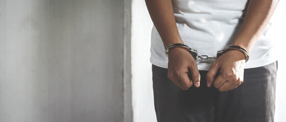 Prisoner man with handcuffs in his arms