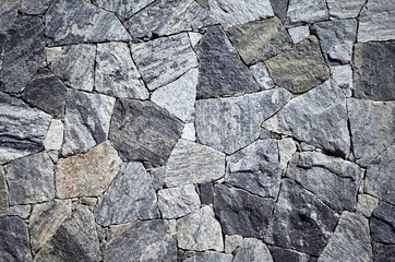 Wallpaper made of marble pieces of various shapes and sizes, rough surface texture or background.