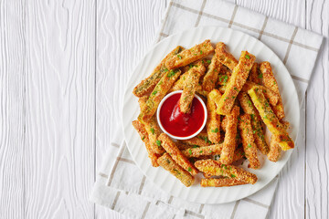 crunchy zucchini sticks on a white plate