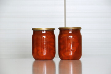 two glass jars with apricot jam homemade from organic products