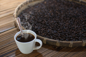 coffee cup with coffee beans on  table