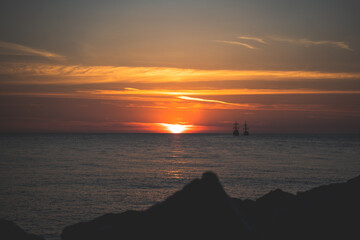 Ships in the sea at sunset