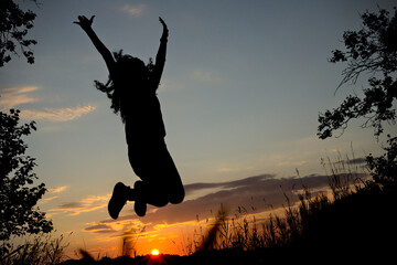 Silhouette of Young Women Jumping