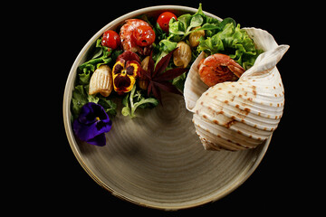 grilled shrimps and vegetable salad on black plate