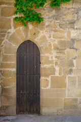 Fototapeta na wymiar Antique door in stone wall