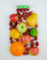 Creative form of fresh fruit in shape of jar on white background. Top view. Healthy eating concept.
