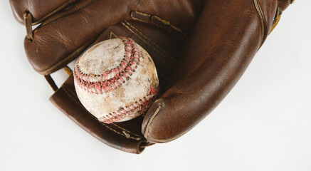 Leather baseball glove and ball isolated on white background, vintage style texture.