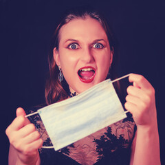 Female vampire with red hair for halloween during quarantine of coronavirus. Angry look of vamp...