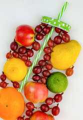 Fresh fruit in shape of glass with drinking pipe on white background. Top view. Natural food concept.