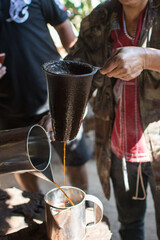 Coffee grinder and boiling water to brew coffee of the hill tribe people at Doi Inthanon National Park, Thailand