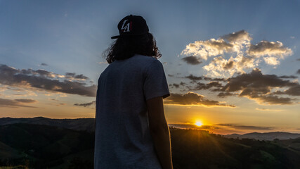 Boy walking in a beautiful sunset in brazil