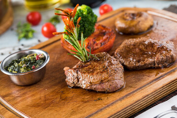 Tenderloin Steak Roast beef on wooden cutting board on wooden background