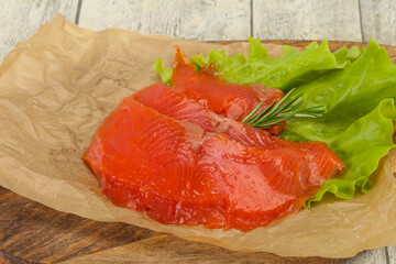 Sliced salmon fillet served rosemary