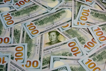 1 yuan banknotes and 100 dollar bills close up