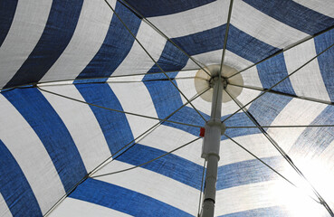 debajo de la sombrilla de rayas azul y blanca protegerse del sol 4M0A9399-as20