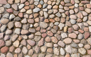 The road is lined with round cobblestones