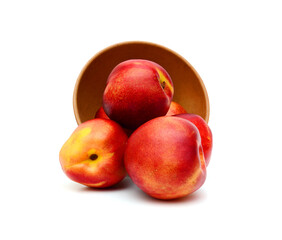Fototapeta na wymiar sweet peaches in wooden bowl on a white background 