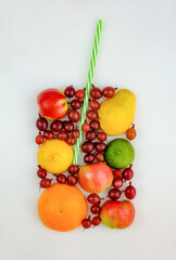 Colorful fruit as form of glass for fresh juice with straw. Summer concept