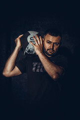 Muscular man exercise with medicine ball at health club. Fitness routine with exercise ball.