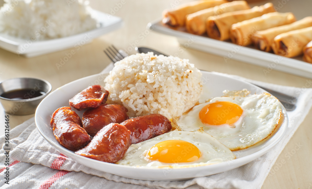 Wall mural filipino silog breakfast with garlic fried rice, longsilog, and two sunny side up eggs