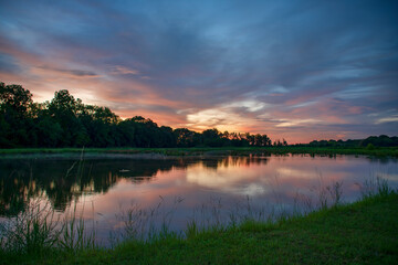 Obraz na płótnie Canvas Sunset on Farm Reflected in Pond in Rural Louisiana