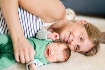 Fototapeta na wymiar Happy mother with crying newborn