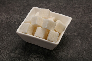 Refined white sugar cubs in the bowl