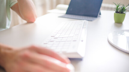 the developer works at the computer, typing, uses the mouse. Selective focus