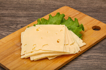 Sliced yellow cheese over board