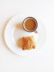 Cup of coffee with puff bun on the plate,photo