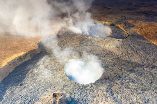 Smoke over the two craters of Erta Ale volcano summit caldera, Danakil Depression, Afar Region, Ethiopia