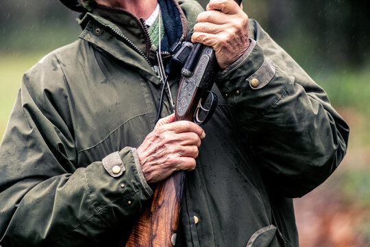 Hands holding a gun ready to shoot