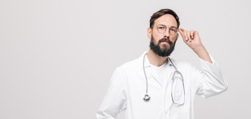 close-up portrait of young male doctor in uniform with stethoscope. medical concept