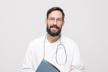 smiling male doctor in uniform with stethoscope reading medical document.