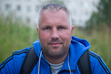 Portrait of a man who is engaged in fitness training on the street.