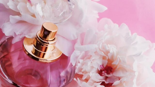 Pink perfume bottle with peony flowers, chic fragrance scent as luxury cosmetic, fashion and beauty product backgrounds