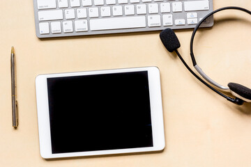 call center manager work desk with tablet and headset top view