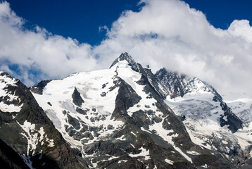 spectacular view of clouds over the snow covered mountains at the summit of Grossglockner in the austrian alps