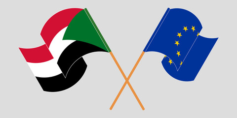 Crossed and waving flags of Sudan and the EU