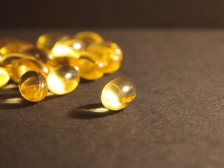 Trans-lucid cod liver oil pills under colourful light